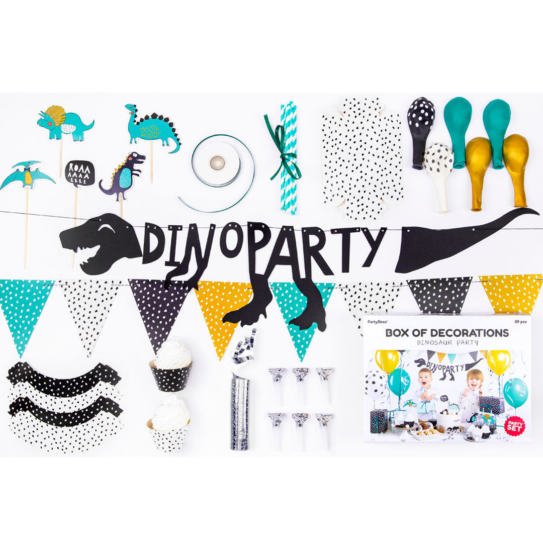 Detalle del set de decoración para fiestas de dinosaurios en tonos verde y plateado. Incluye globos, guirnalda y toppers.