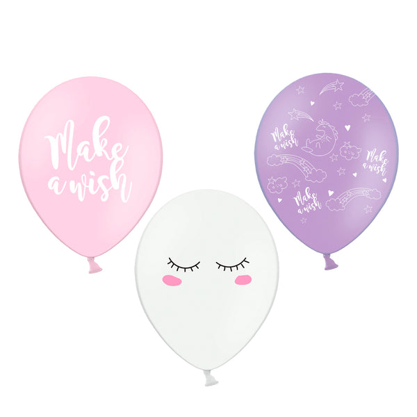 Detalle del pack de 3 globos Unicornio: rosa con texto Make a Wish, lila con unicornios y blanco con carita. Tamaño 30 cm.