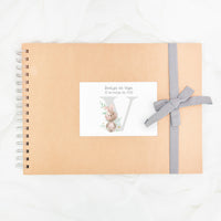 Libro de firmas personalizado para bautizo con diseño y lazo en color gris.