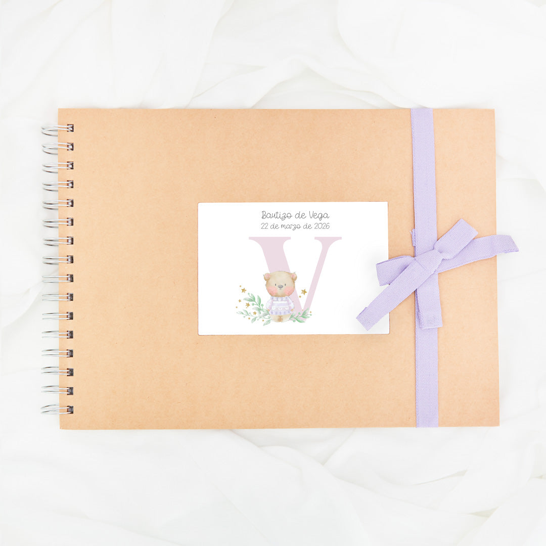 Libro de firmas personalizado para bautizo con diseño y lazo en color lila.