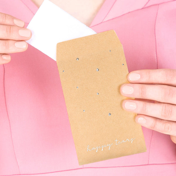 Sobres kraft con inscripción plateada “Happy Tears”, detalle de boda con pañuelos para lágrimas de felicidad.
