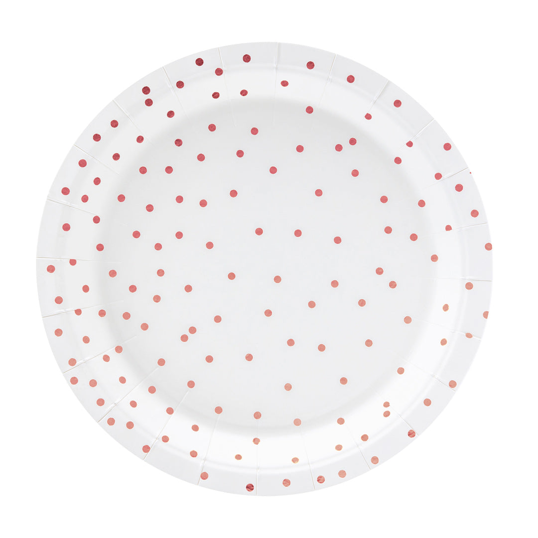 Detalle de los platos de papel blancos con topos en color oro rosa. 