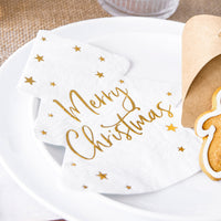 Servilletas con forma de árbol de Navidad blanco y dorado sobre mesa festiva