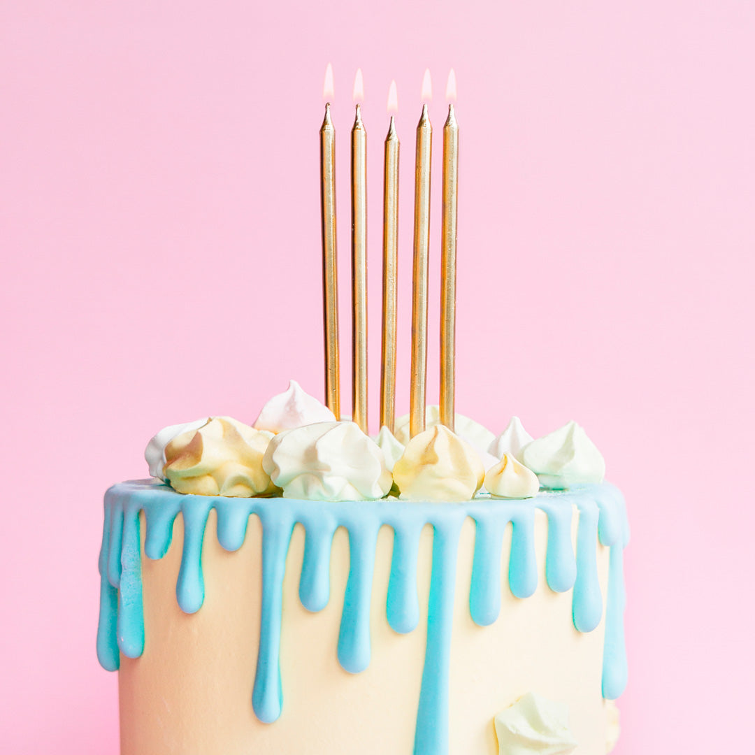 velas de cumpleaños metalizadas en color dorado en tarta. 